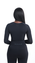 Back view of Black Shavo Long Sleeve Top. Matching black Shavo seamless legging pictured. Legging has monochrome black Roam Loud logo centered on back.