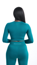 Back view of Turquoise Shavo Seamless Legging. Monochromatic Roam Loud centered on the back of legging. Back of matching long sleeved  top also pictured.
