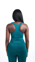 Back view of Woman wearing a green colored seamless bra