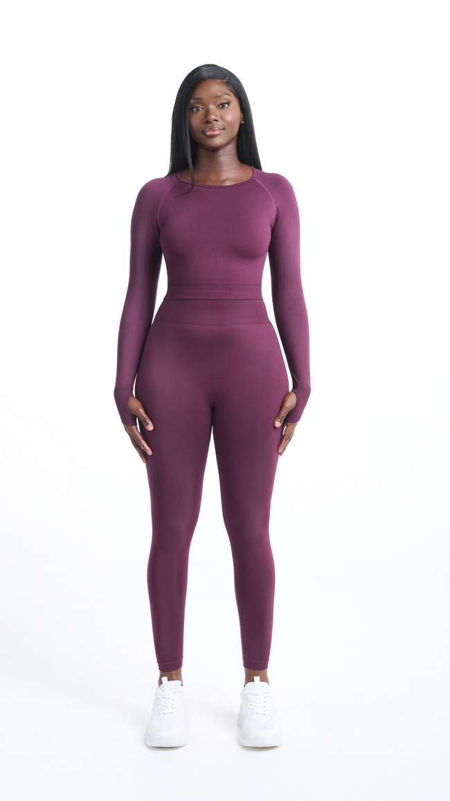 Full front view of woman wearing a purple Shavo Long Sleeved top. Matching legging is also pictured.