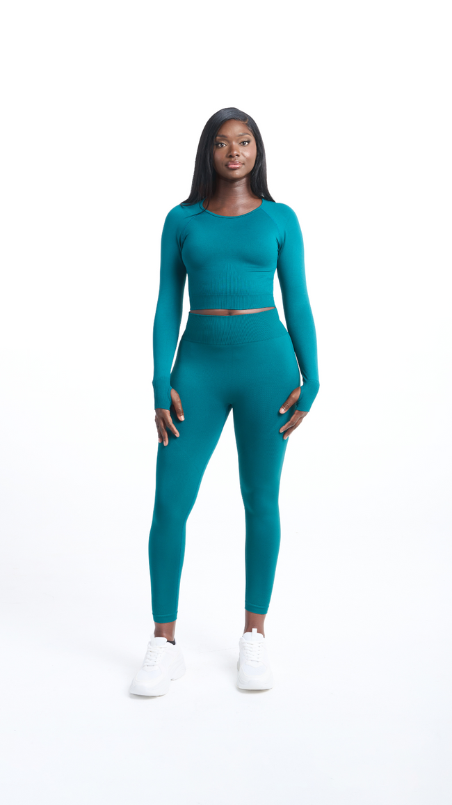 Full front view of woman wearing a Turquoise Shavo legging. Matching Shavo Long Sleeved top is also pictured.